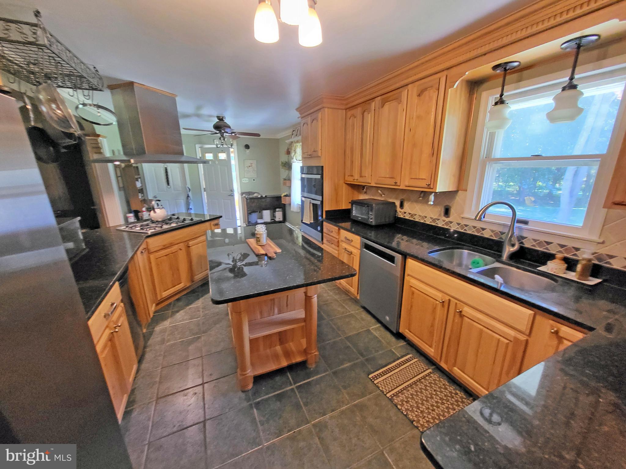 90 Knoxlyn-Orrtanna Road Gettysburg, PA 17325 - Photo 8 of 32 a kitchen with stainless steel appliances granite countertop a sink stove and cabinets