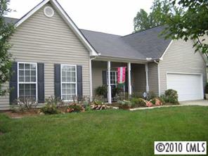 a view of a house with garden and yard