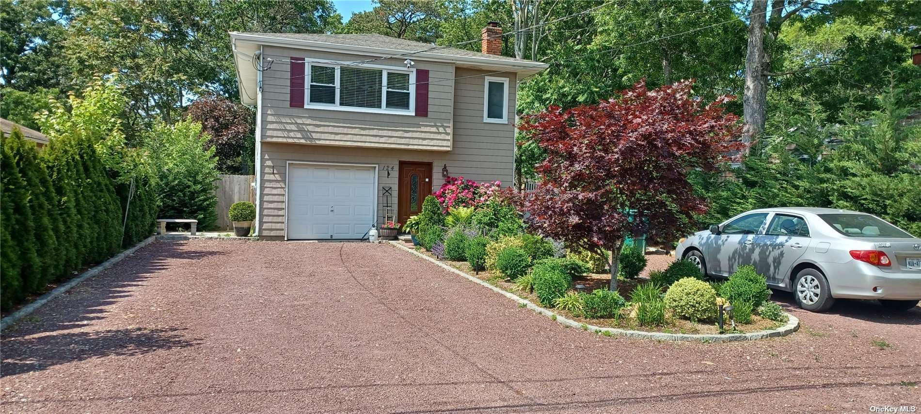 124 Riverside Avenue Flanders, NY 11901 - Photo 1 of 1 a front view of a house with a garden