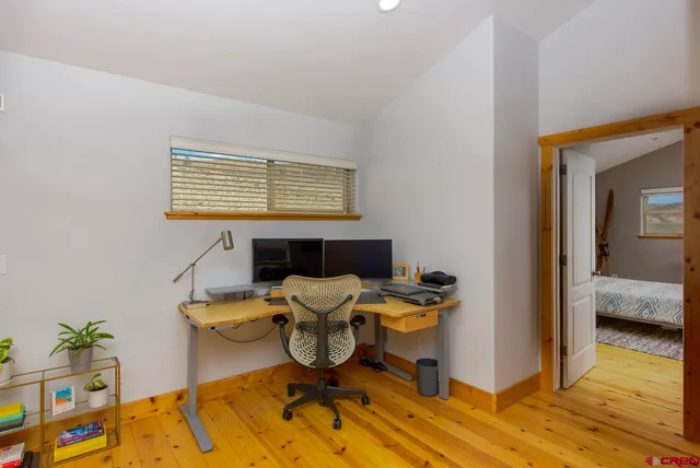 a workspace with furniture and wooden floor
