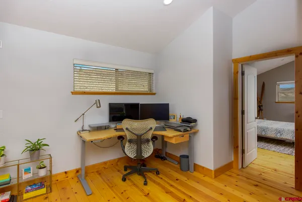 a workspace with furniture and wooden floor