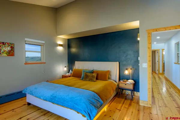 a bedroom with a bed and lamps