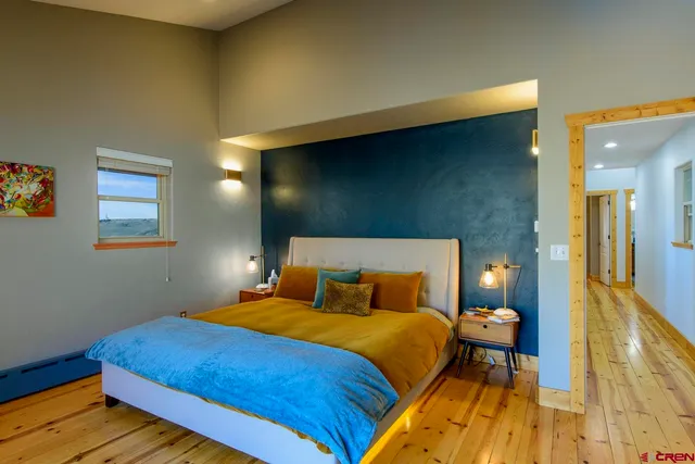 a bedroom with a bed and lamps