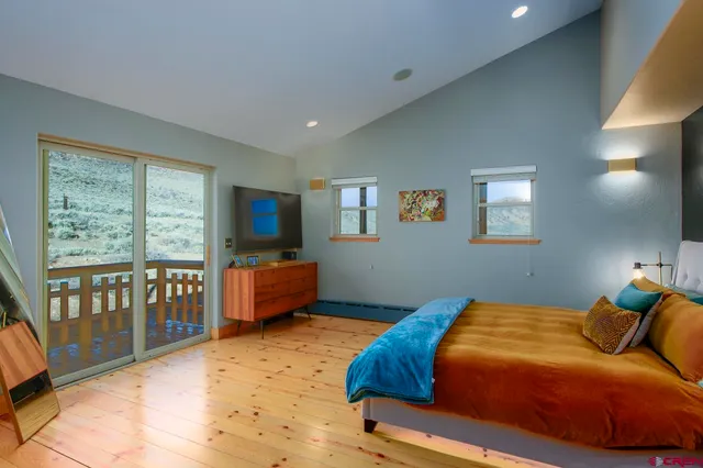 a bedroom with a bed and a television