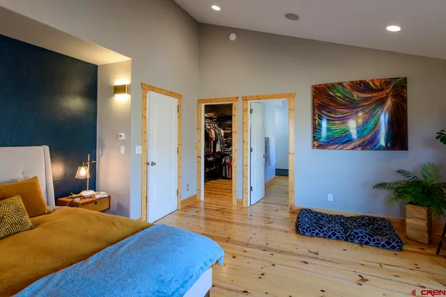 a bedroom with a bed and a painting on the wall