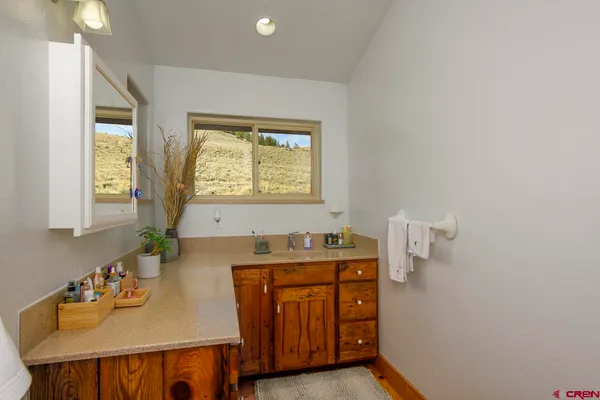 a bathroom with a sink a vanity and a mirror