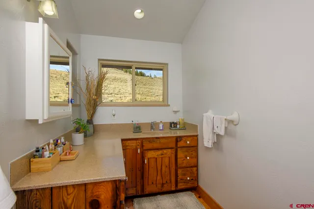 a bathroom with a sink a vanity and a mirror