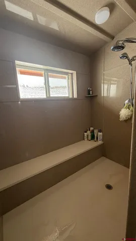 a bathroom with a tub and shower