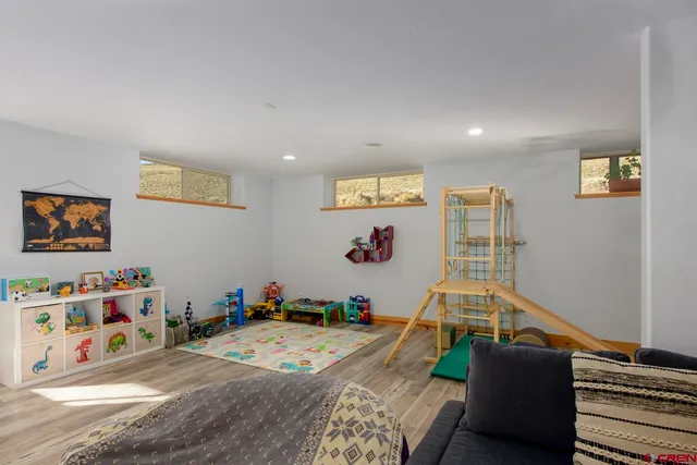 a bedroom with bed and a flat screen tv
