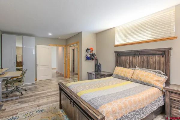 a bed sitting in a bedroom next to a window
