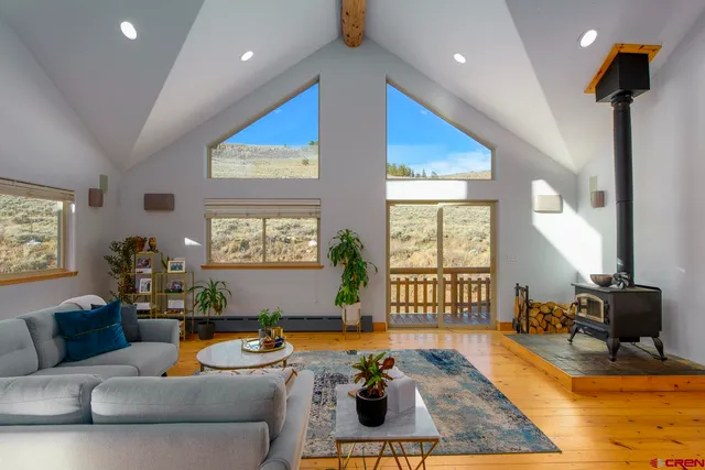a living room with furniture fireplace and a large window