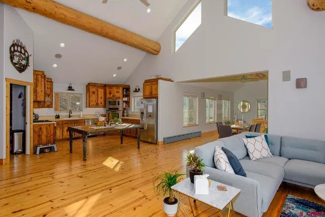 a living room with furniture and kitchen view