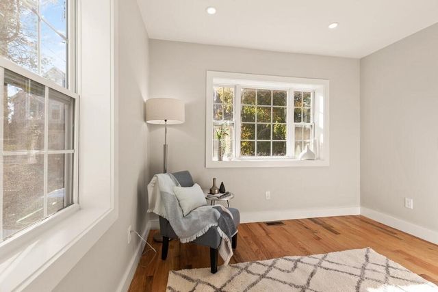 a kitchen with stainless steel appliances a refrigerator a stove a sink dishwasher and white cabinets with wooden floor