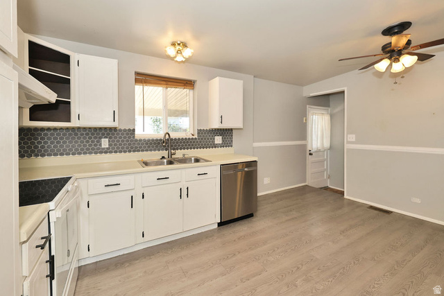669 Colonial Avenue Layton, UT 84041 - Photo 8 of 51 White cabinetry with black hardware, stainless steel dishwasher, dual basin sink, hexagonal tile backsplash, and wood-finish flooring