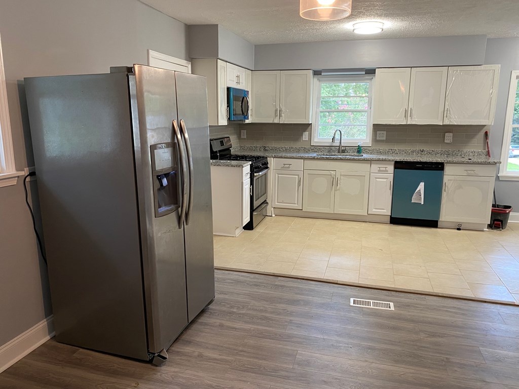 1061 Dunbar Avenue Columbus, GA 31906 - Photo 3 of 11 a kitchen with stainless steel appliances a refrigerator sink and cabinets