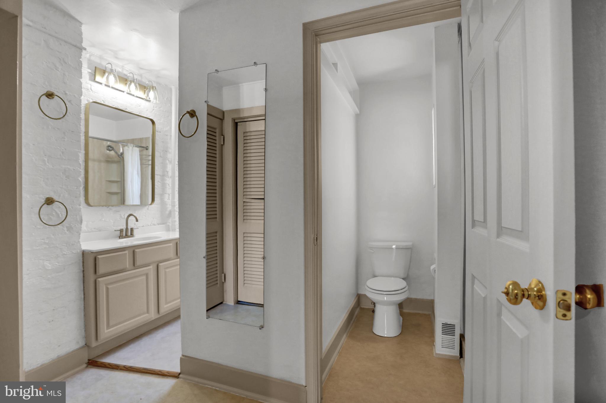 1306 Rutter Street Baltimore, MD 21217 - Photo 14 of 27 a bathroom with a toilet sink and shower a mirror