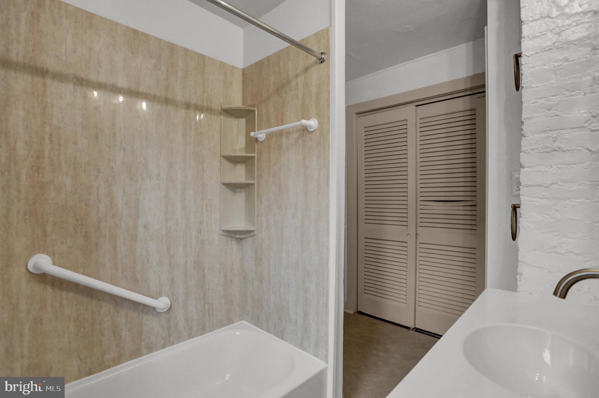 1306 Rutter Street Baltimore, MD 21217 - Photo 16 of 27 a bathroom with a sink a shower and a window