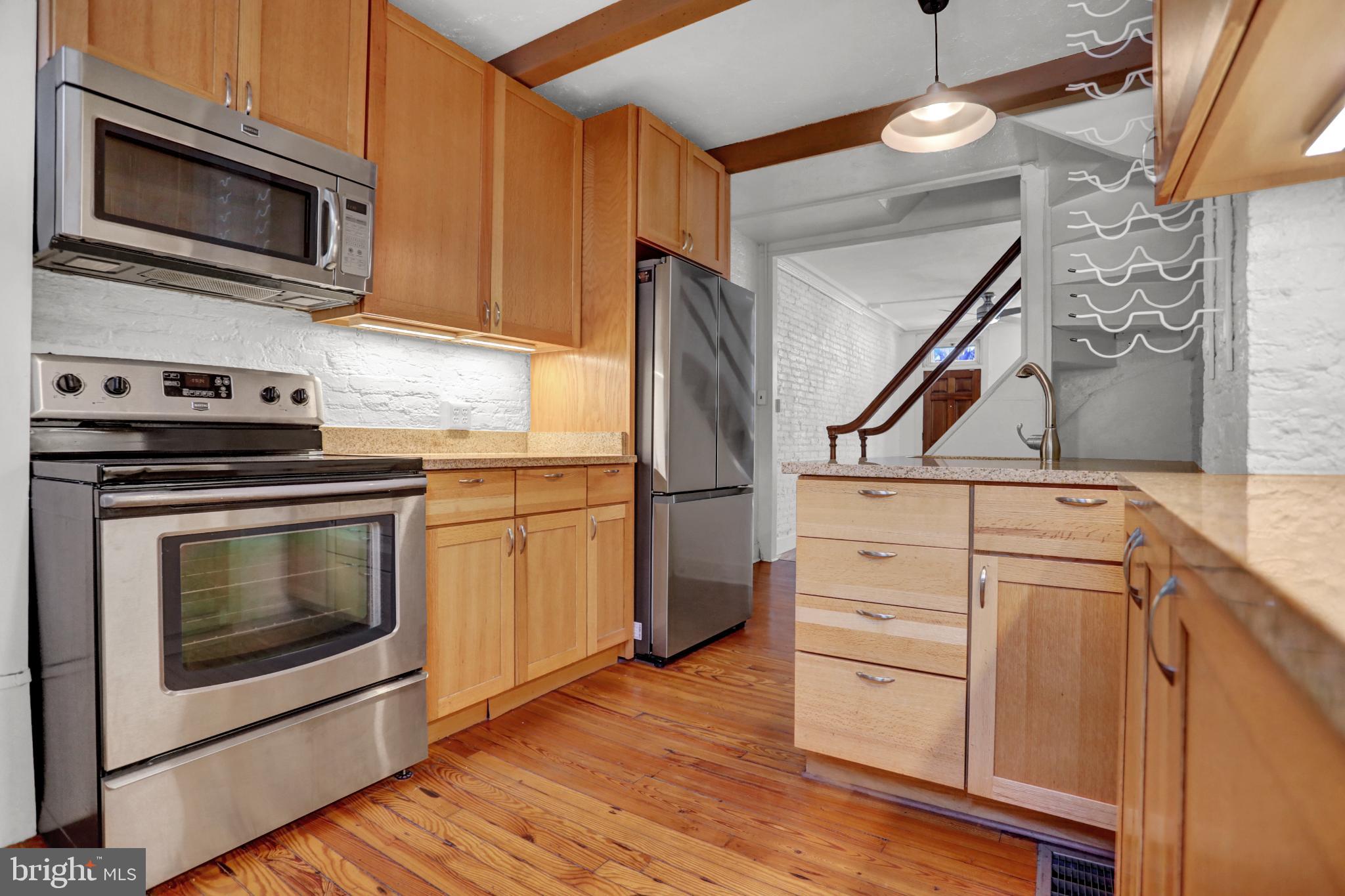 1306 Rutter Street Baltimore, MD 21217 - Photo 5 of 27 a kitchen with appliances cabinets and a wooden floor