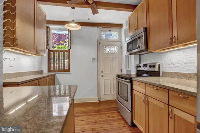 a kitchen with stainless steel appliances granite countertop a sink and cabinets