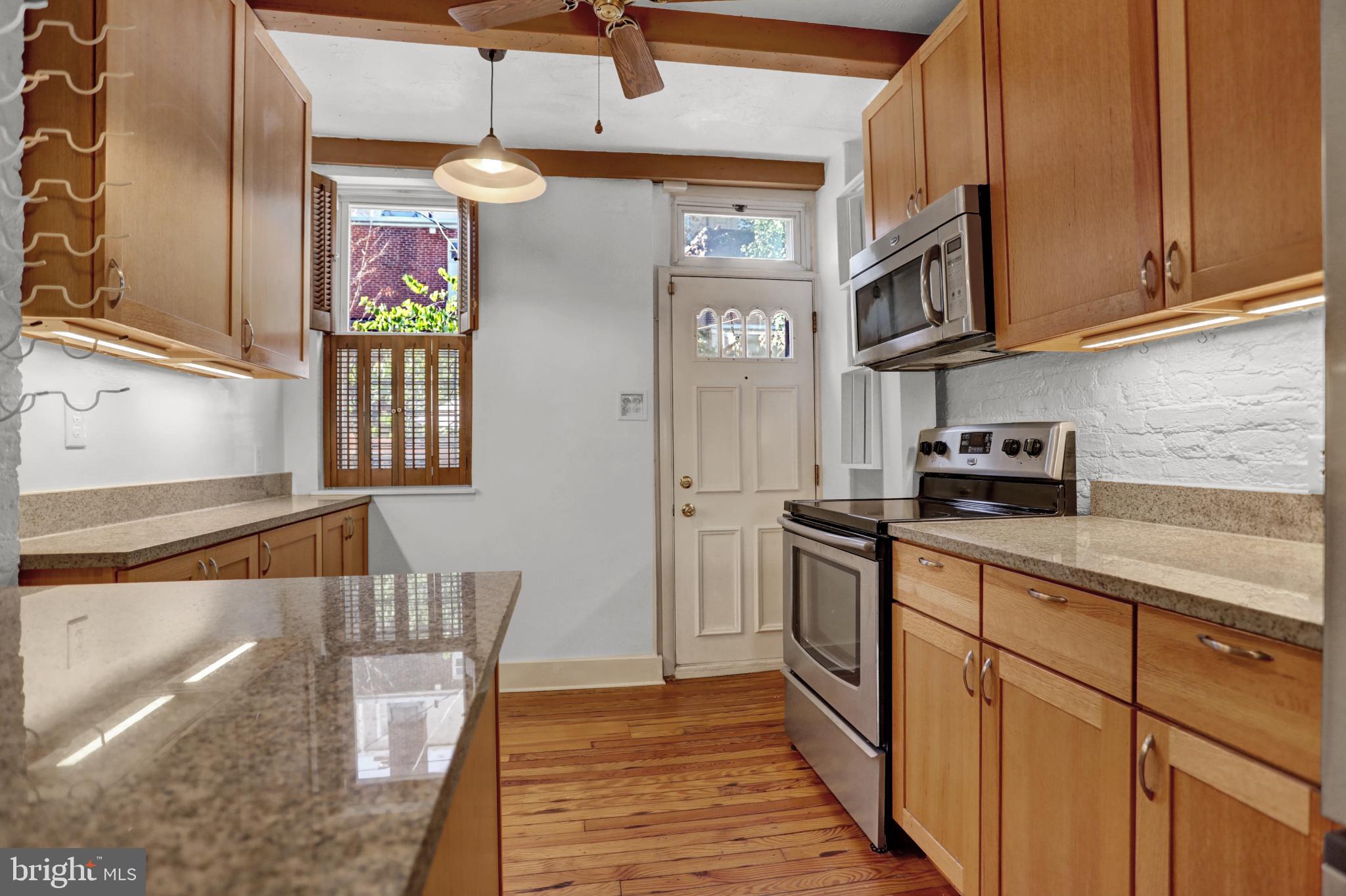 1306 Rutter Street Baltimore, MD 21217 - Photo 8 of 27 a kitchen with stainless steel appliances granite countertop a sink and cabinets