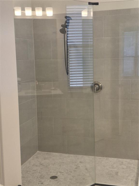 12618 Vander Way New Port Richey, FL 34654 - Photo 3 of 22 a bathroom with a shower