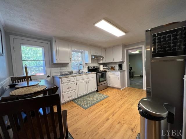 7338 Red House Road Appomattox, VA 24522 - Photo 3 of 28 a kitchen with granite countertop a sink stainless steel appliances and cabinets