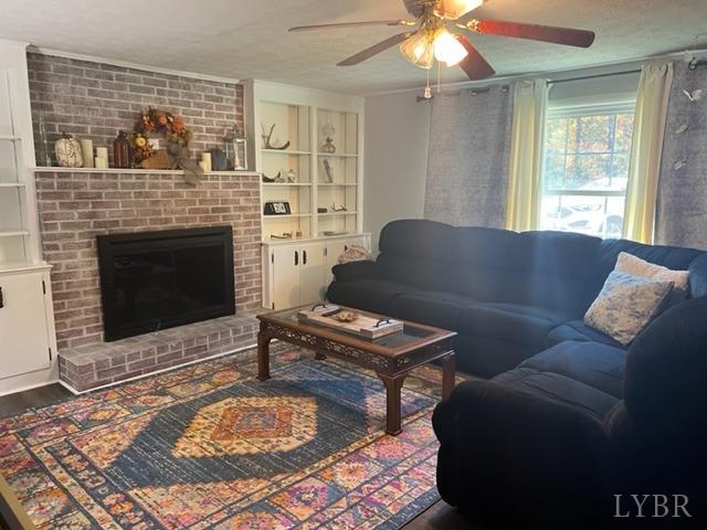 7338 Red House Road Appomattox, VA 24522 - Photo 5 of 28 a living room with furniture a flat screen tv and a fireplace