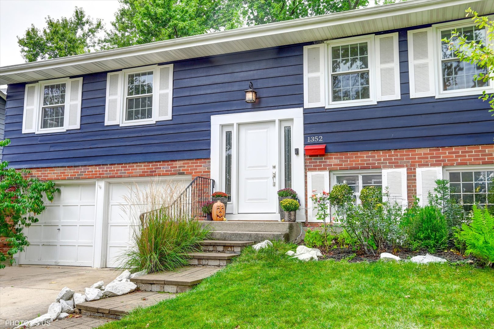 a front view of a house with garden