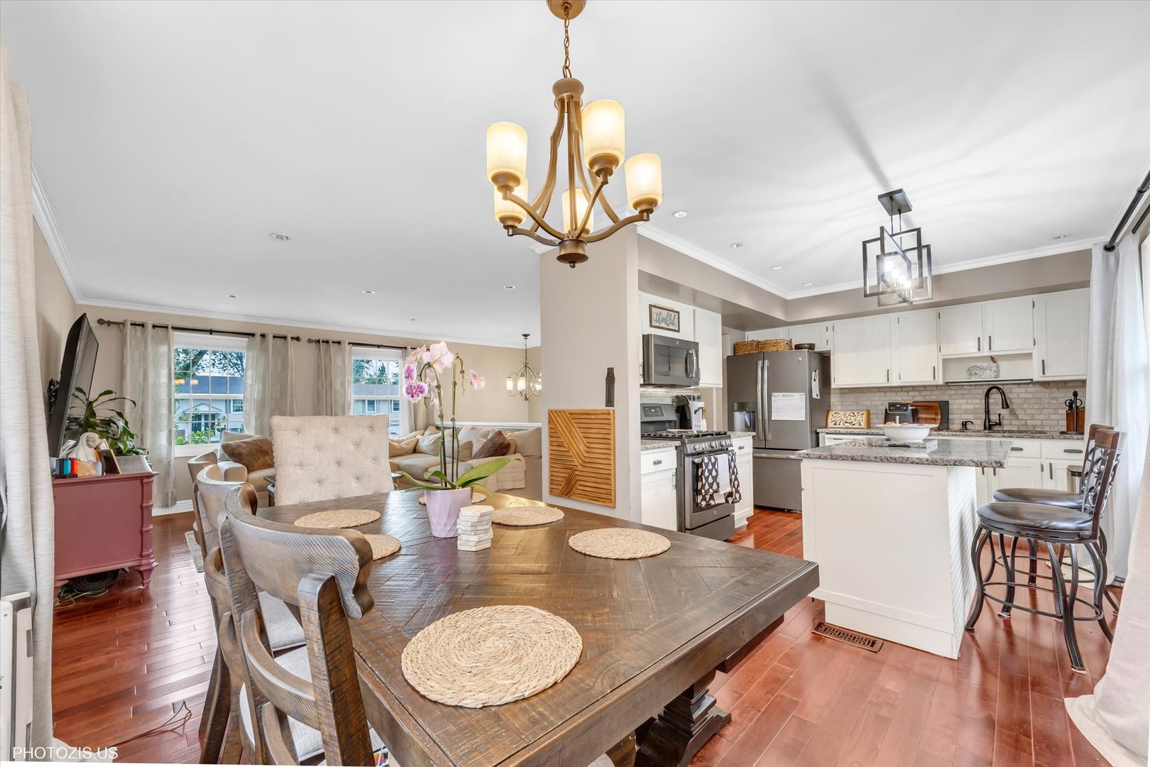 1352 West Oakmont Road Hoffman Estates, IL 60169 - Photo 18 of 42 a view of a dining room and livingroom with furniture wooden floor a chandelier