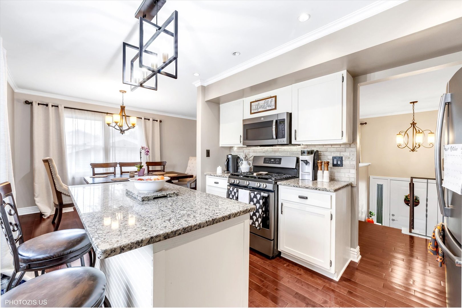 1352 West Oakmont Road Hoffman Estates, IL 60169 - Photo 21 of 42 a kitchen with stainless steel appliances granite countertop a stove top oven a refrigerator a sink and dishwasher with wooden floor