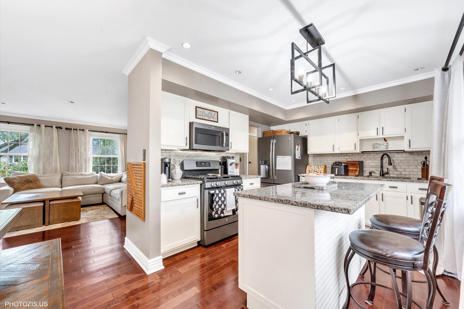 1352 West Oakmont Road Hoffman Estates, IL 60169 - Photo 23 of 42 a kitchen with stainless steel appliances granite countertop a refrigerator a stove top oven a sink dishwasher a dining table and chairs with wooden floor