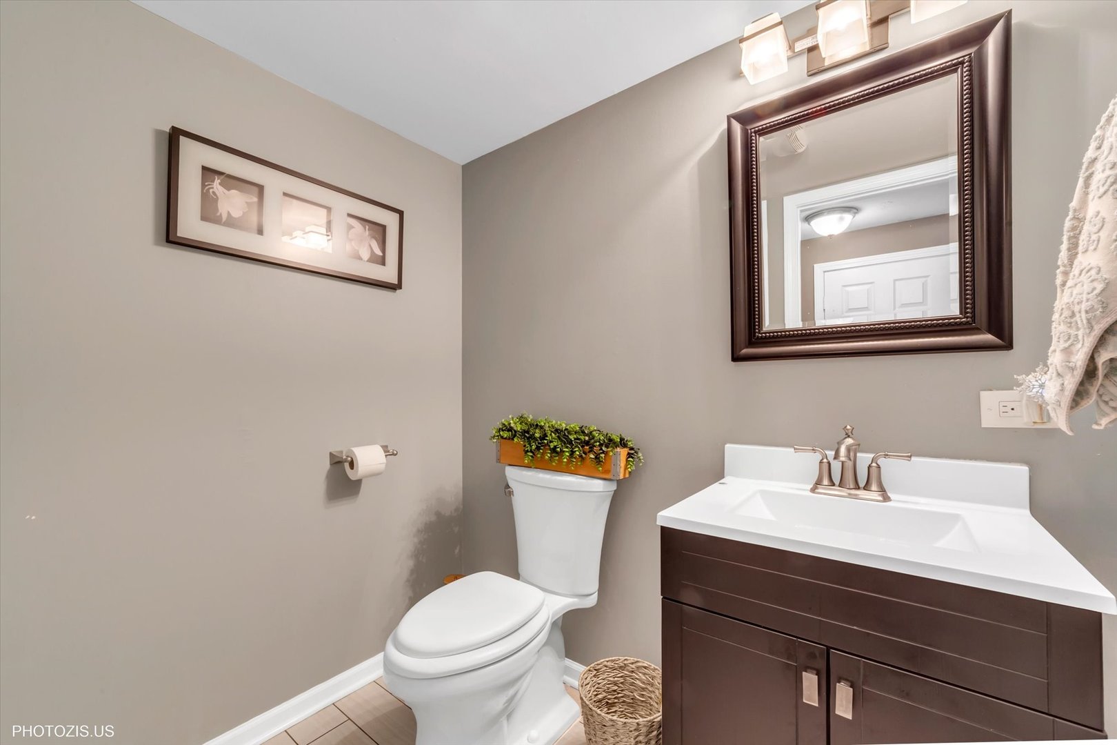 1352 West Oakmont Road Hoffman Estates, IL 60169 - Photo 35 of 42 a bathroom with a toilet a sink and mirror