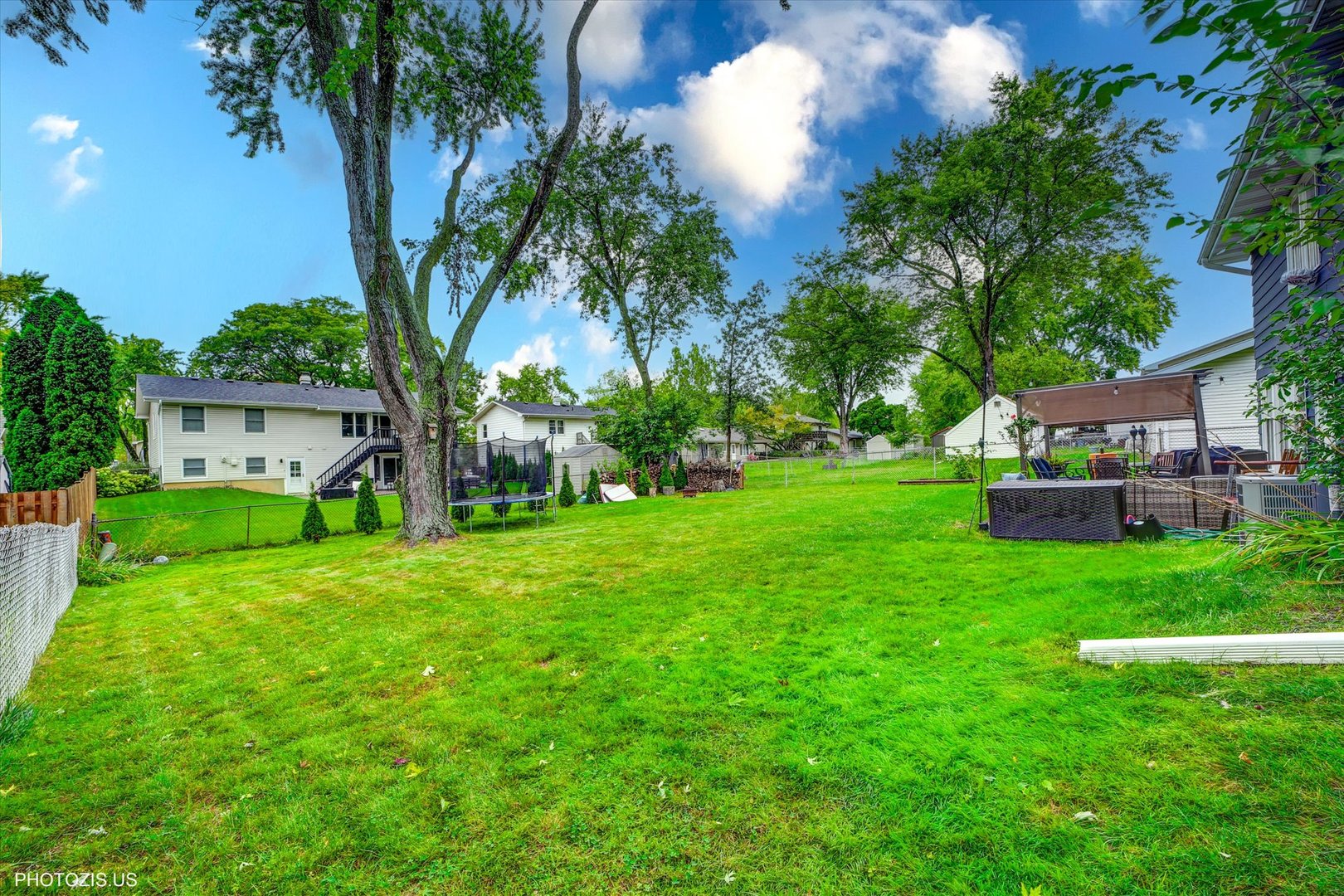 1352 West Oakmont Road Hoffman Estates, IL 60169 - Photo 7 of 42 a view of a house with a big yard and potted plants and large trees