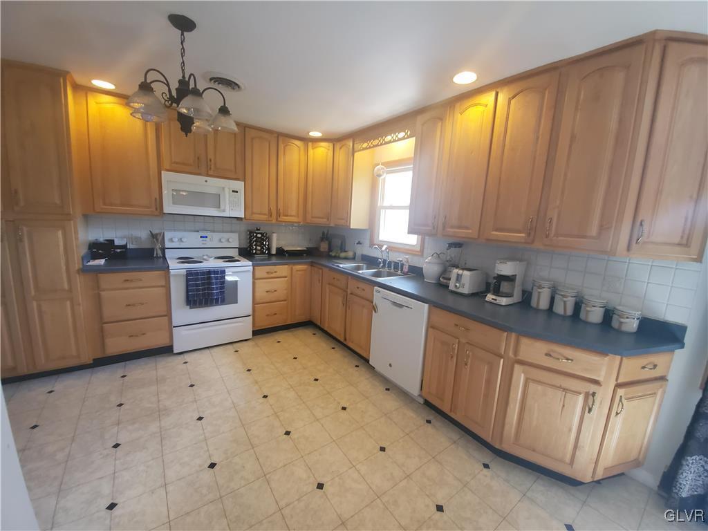 3556 Mountain Road Slatington, PA 18080 - Photo 3 of 31 a kitchen with stainless steel appliances granite countertop a stove a sink dishwasher and a refrigerator