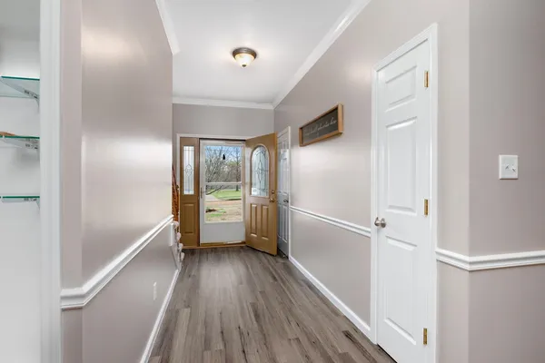 a view of empty room with wooden floor