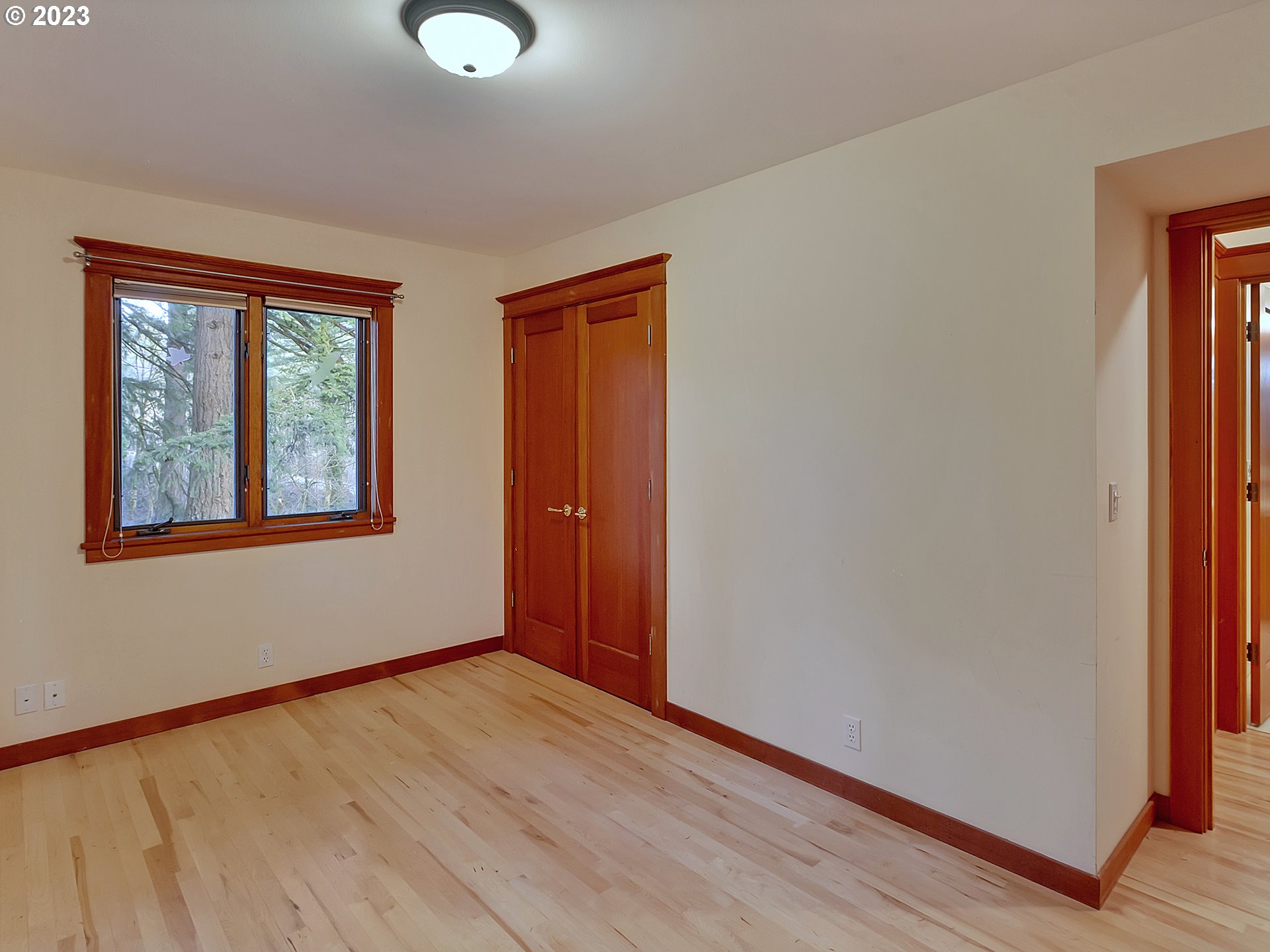 11310 Northwest Plainview Road Portland, OR 97231 - Photo 14 of 32 a view of an empty room with window and wooden floor