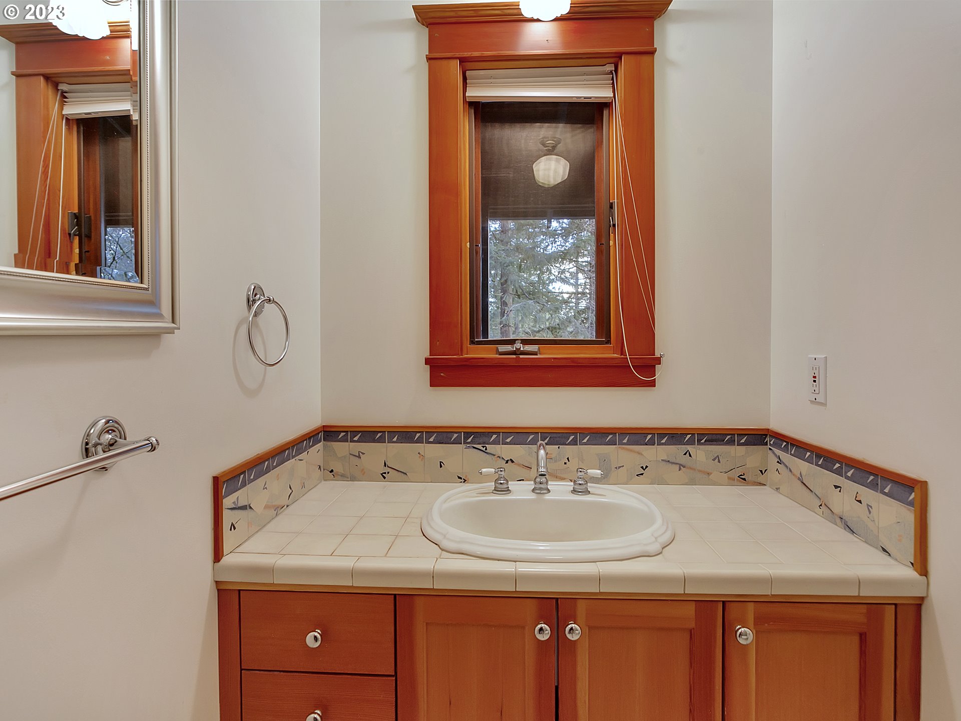 11310 Northwest Plainview Road Portland, OR 97231 - Photo 16 of 32 a bathroom with a sink and a mirror