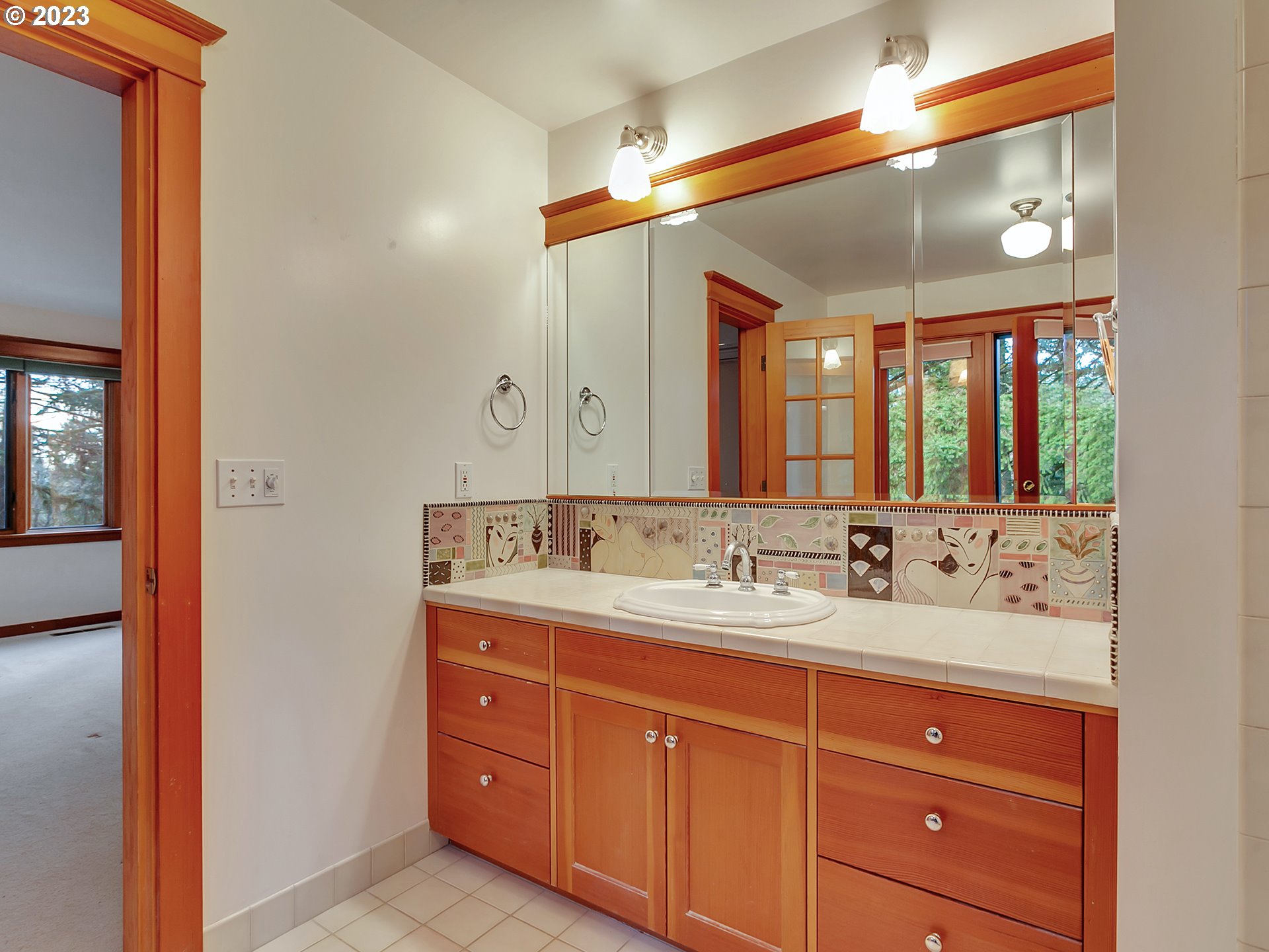 11310 Northwest Plainview Road Portland, OR 97231 - Photo 22 of 32 a bathroom with a double vanity sink and a mirror