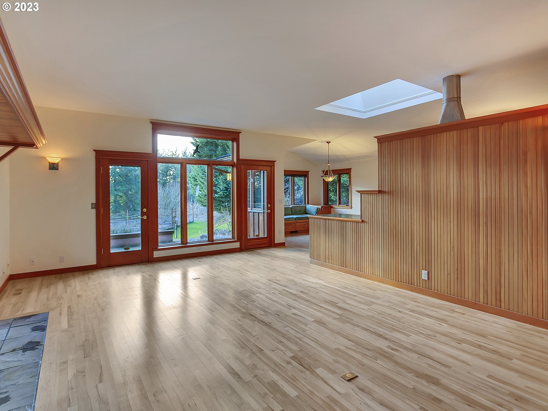 11310 Northwest Plainview Road Portland, OR 97231 - Photo 5 of 32 a view of an empty room with wooden floor and a window