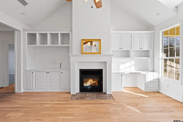 a kitchen with stainless steel appliances granite countertop a sink a stove and a wooden floors