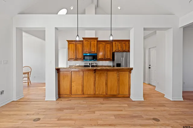 a view of a livingroom with wooden floor and a fireplace