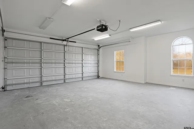 a view of a room with a ceiling fan and window