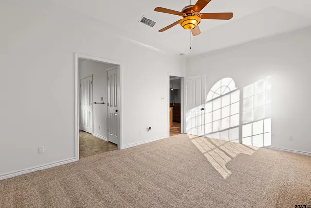 a bathroom with a granite countertop sink a mirror and a bathtub