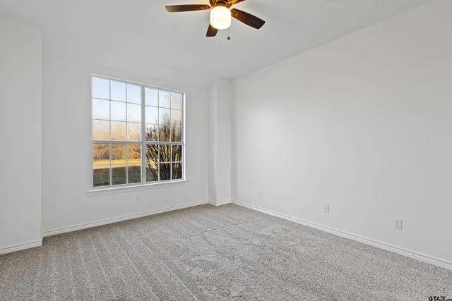 a bathroom with a granite countertop sink toilet and a mirror