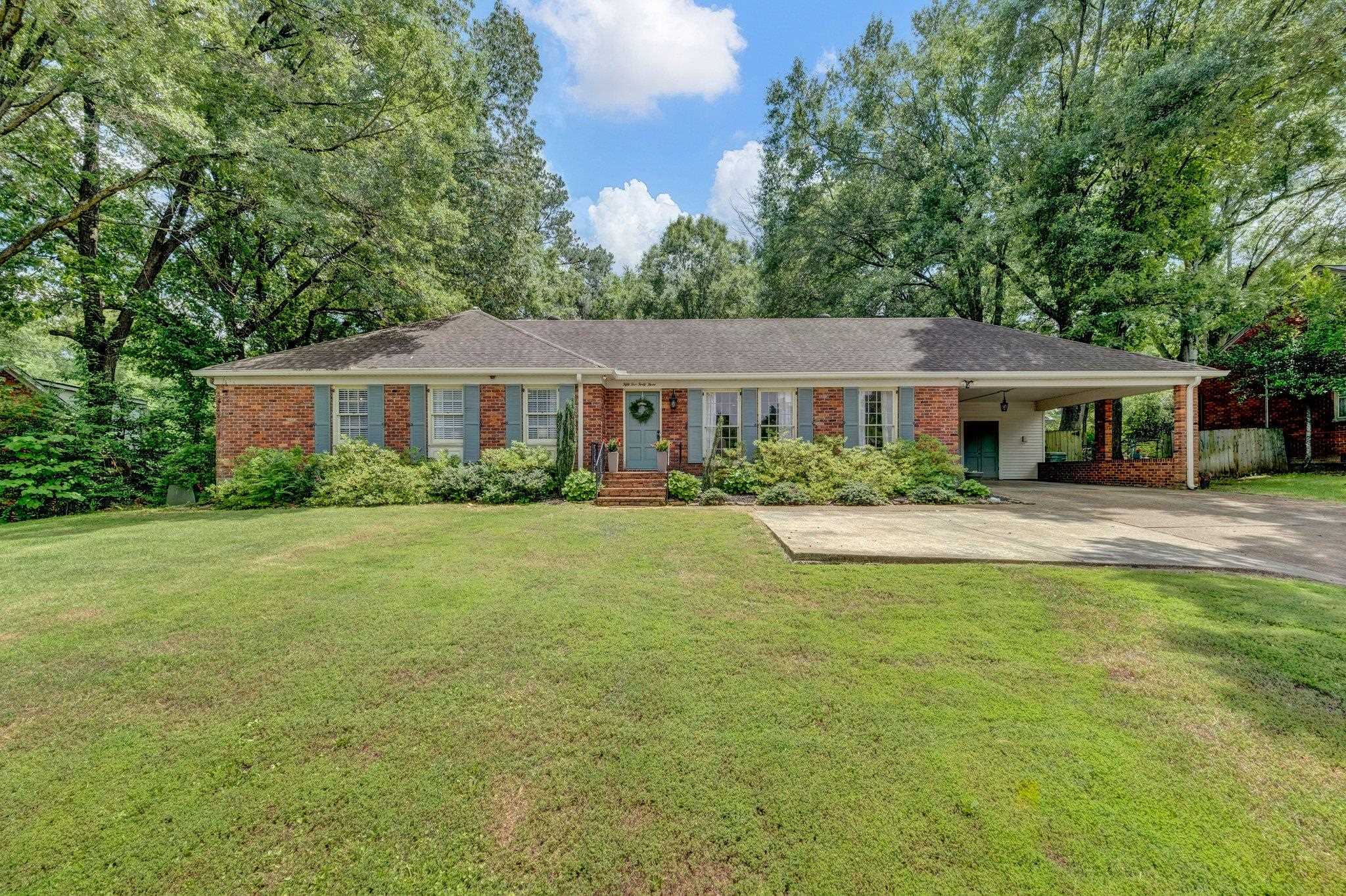 5543 Walnut Grove Road Memphis, TN 38120 - Photo 1 of 25 a front view of a house with a yard table and chairs