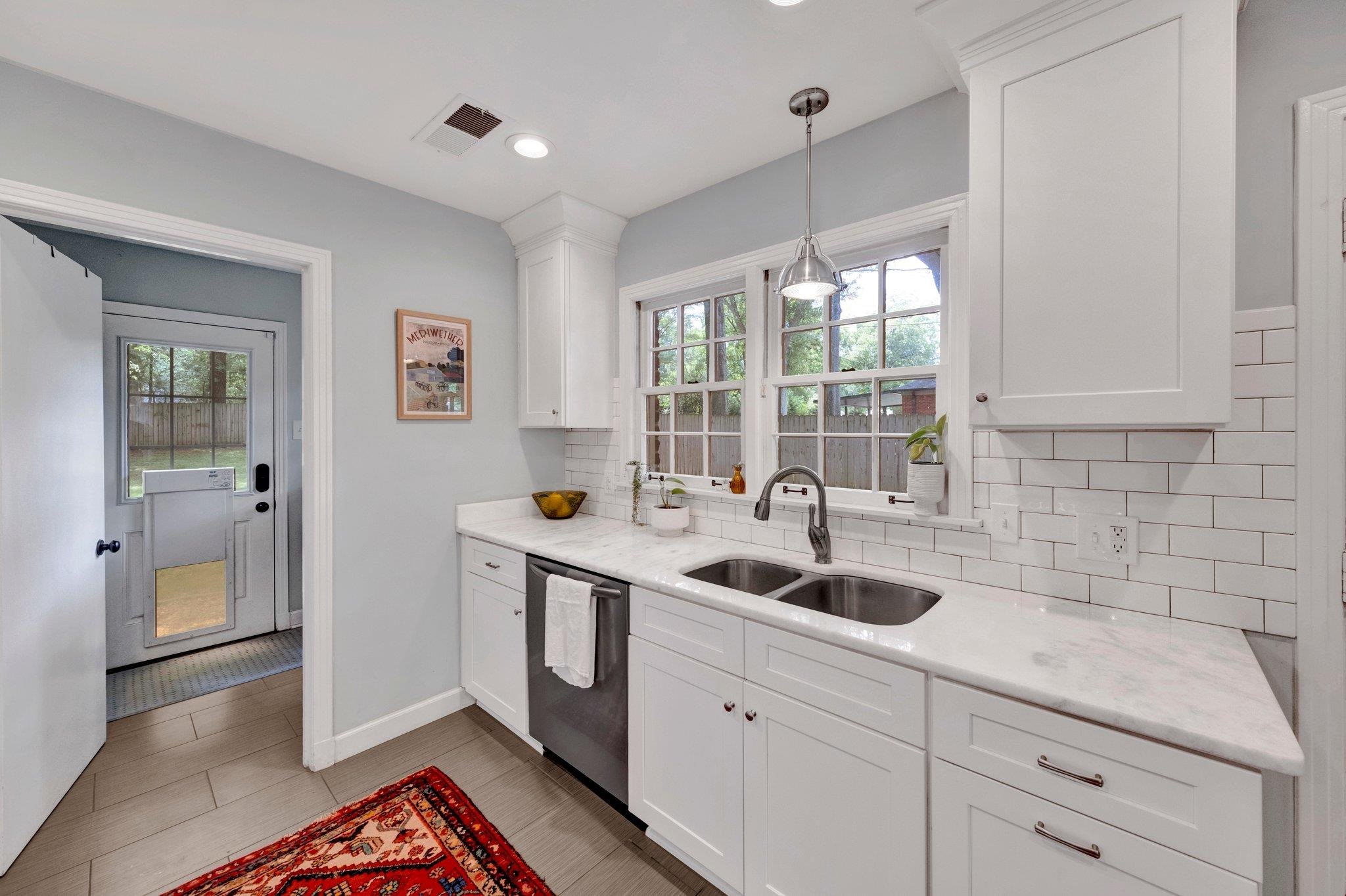 5543 Walnut Grove Road Memphis, TN 38120 - Photo 12 of 25 a kitchen with a sink and cabinets