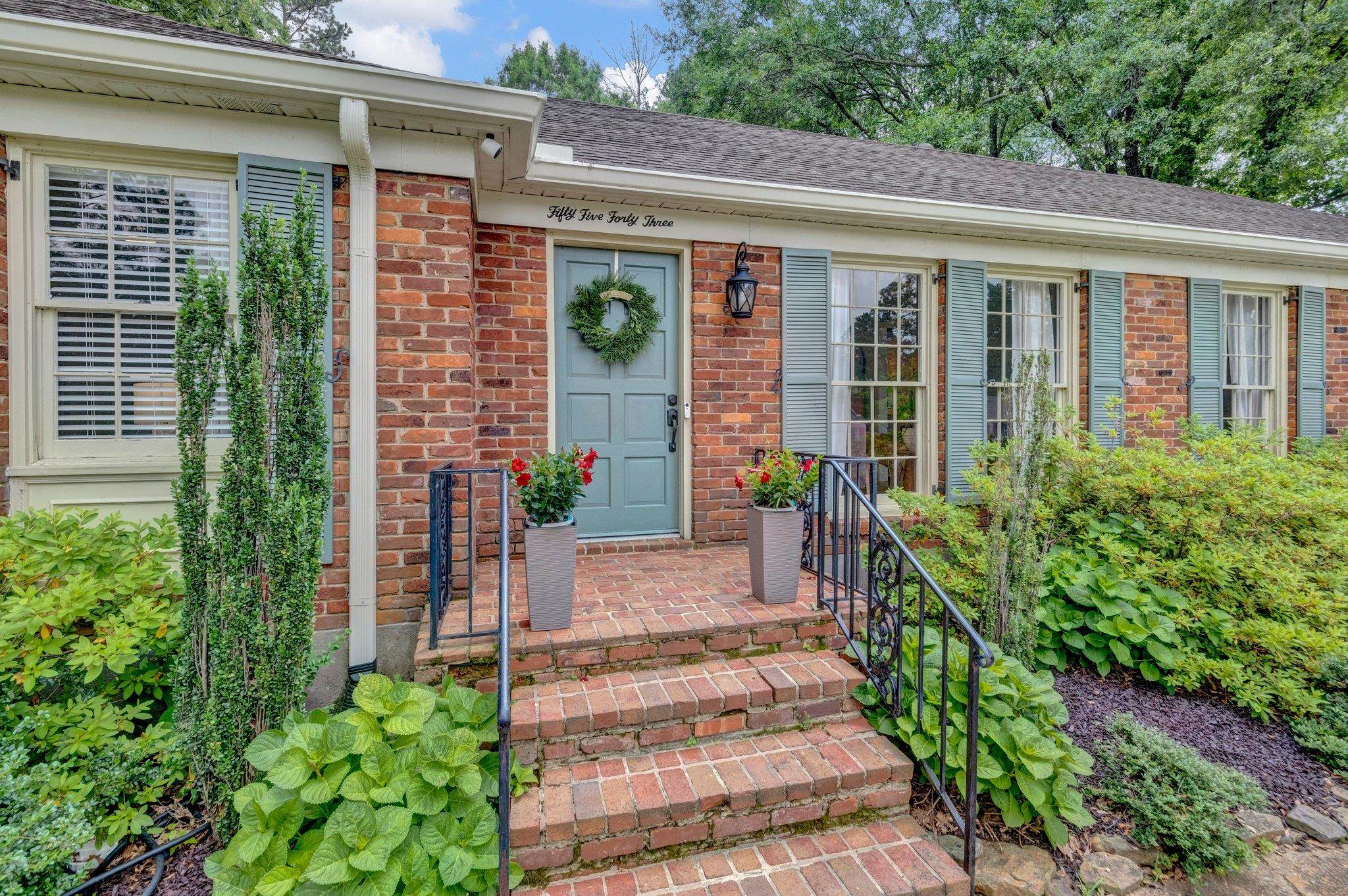 5543 Walnut Grove Road Memphis, TN 38120 - Photo 2 of 25 a front view of a house with a garden