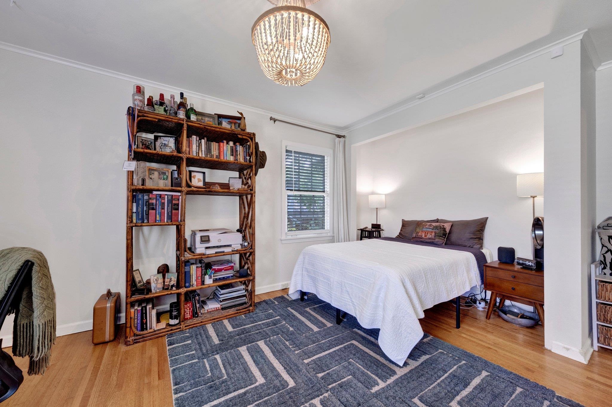 5543 Walnut Grove Road Memphis, TN 38120 - Photo 22 of 25 a bedroom with a bed and a book shelf