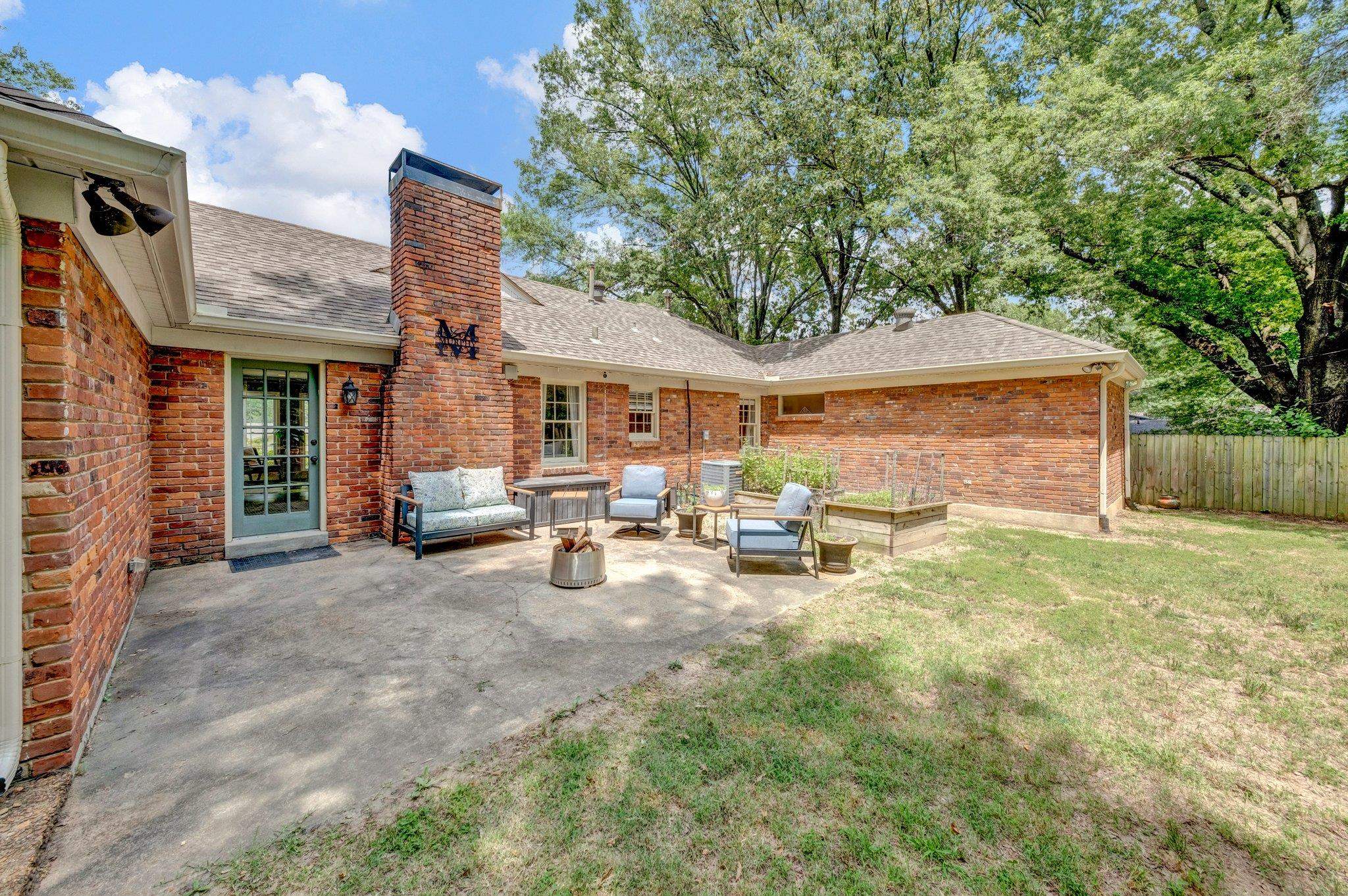 5543 Walnut Grove Road Memphis, TN 38120 - Photo 23 of 25 a view of a house with backyard porch and sitting area