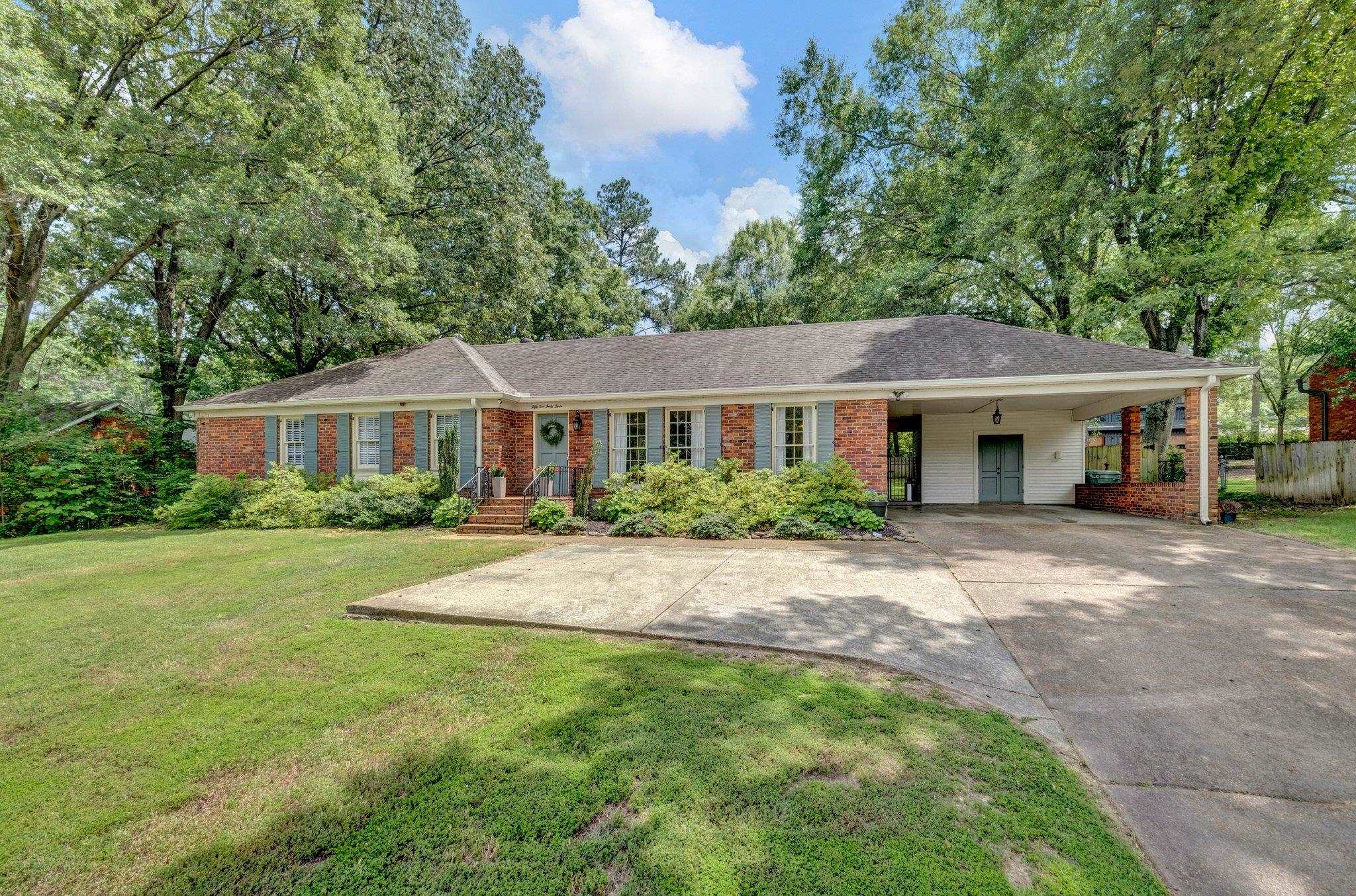 5543 Walnut Grove Road Memphis, TN 38120 - Photo 25 of 25 a front view of a house with a garden
